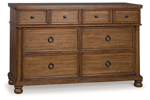 Ashley Furniture Chadworth Dresser with multiple drawers, shown from an angled view in a stylish bedroom setting.