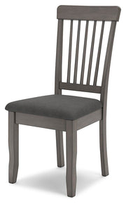 Ashley Furniture Shullden dining room set with a wooden table and six matching chairs, viewed from an angle.