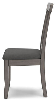 Ashley Furniture Shullden dining room set with a wooden table and matching chairs, shown from a side angle in the image.