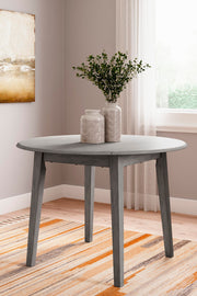 Ashley Furniture Shullden dining room set with a wooden table and matching chairs, shown in a modern dining space.