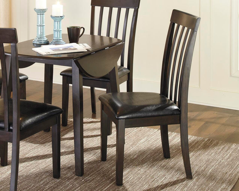 Ashley Furniture Hammis dining chair set featuring four upholstered chairs with dark wood legs, arranged around a dining table.