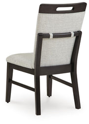 Ashley Furniture Neymorton dining room set with a wooden table and matching chairs, shown from the back view.