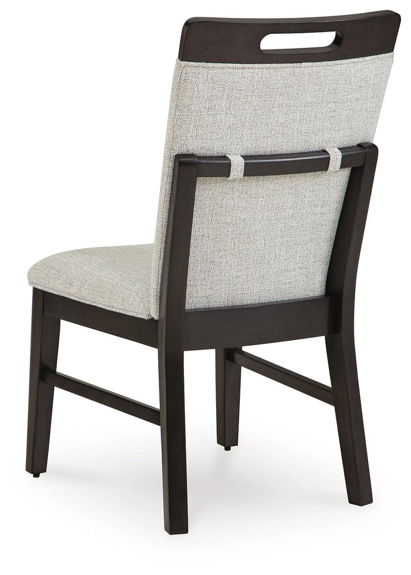 Ashley Furniture Neymorton dining room set with a wooden table and matching chairs, shown from the back view.