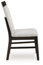 Ashley Furniture Neymorton dining room set with a wooden table and matching chairs, shown from a side angle in a modern dining space.