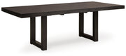 Ashley Furniture Neymorton dining room set with a wooden table and six upholstered chairs, shown from an angled side view.