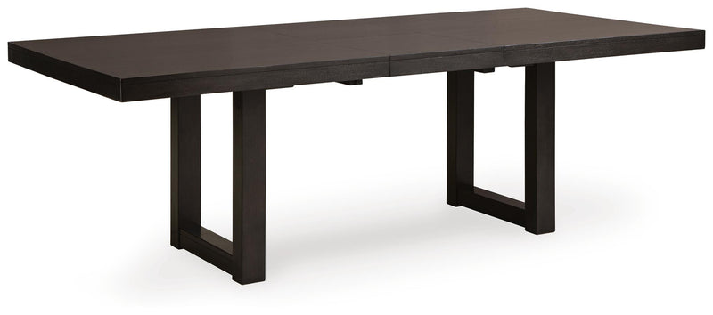 Ashley Furniture Neymorton dining room set with a wooden table and six upholstered chairs, shown from an angled side view.