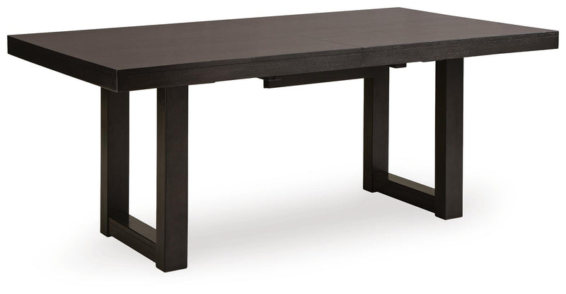 Ashley Furniture Neymorton dining room set with a large table, six chairs, and a leaf extension, shown from an angled side view.
