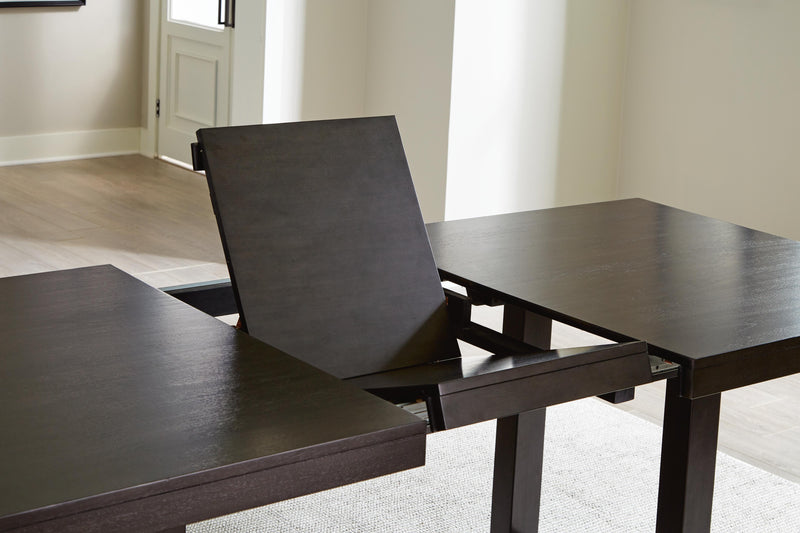 Ashley Furniture Neymorton dining room set with a leaf-shaped table and matching chairs, featuring elegant wood finish and classic design.