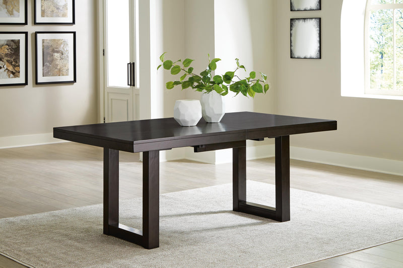 Ashley Furniture Neymorton dining room set with a wooden table and six matching chairs, featuring a leaf design and elegant finish.