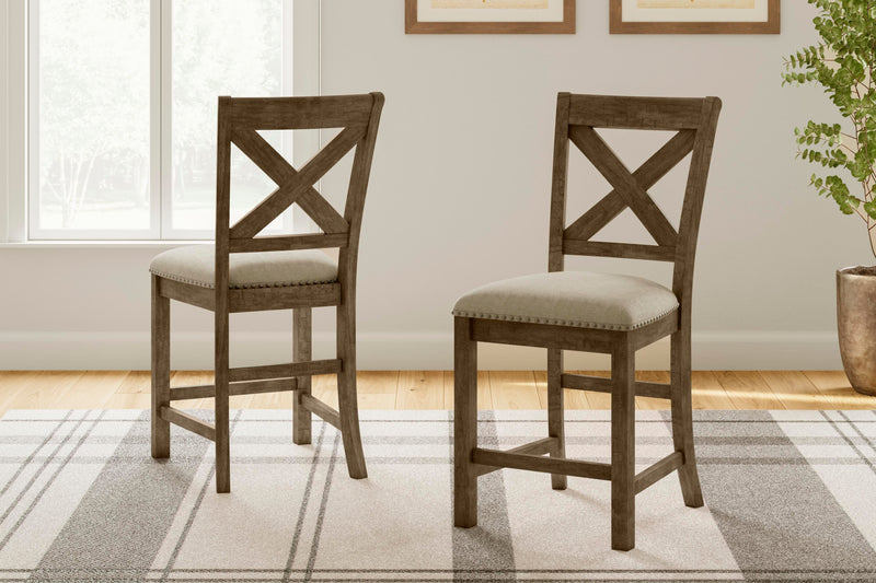 Ashley Furniture Moriville counter height dining set with wooden table and six upholstered chairs in a warm finish.