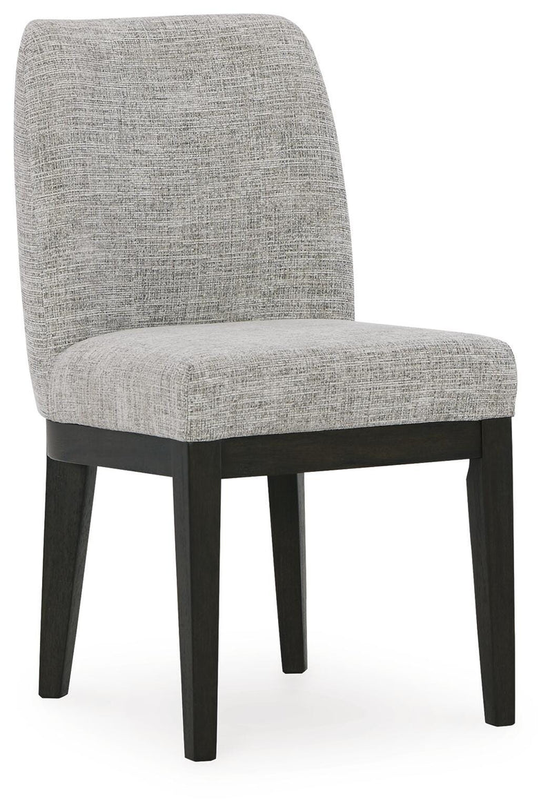 Ashley Furniture Burkhaus dining room set featuring a wooden table and matching chairs, shown from an angled side view.