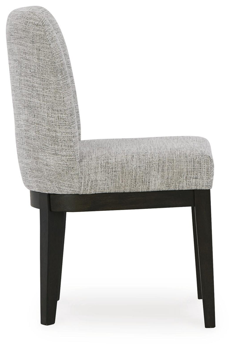 Ashley Furniture Burkhaus dining room set with a wooden table and matching chairs, shown from a side angle.