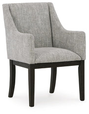 Ashley Furniture Burkhaus dining room set with a wooden table and six upholstered chairs, shown from an angled view.