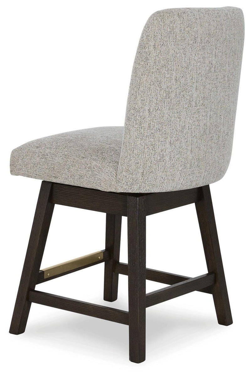 Ashley Furniture Burkhaus dining room set with a wooden table and matching chairs, shown from an angled back view.
