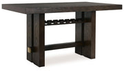 Ashley Furniture Burkhaus dining room set with a wooden table and matching chairs, shown from an angled side view.