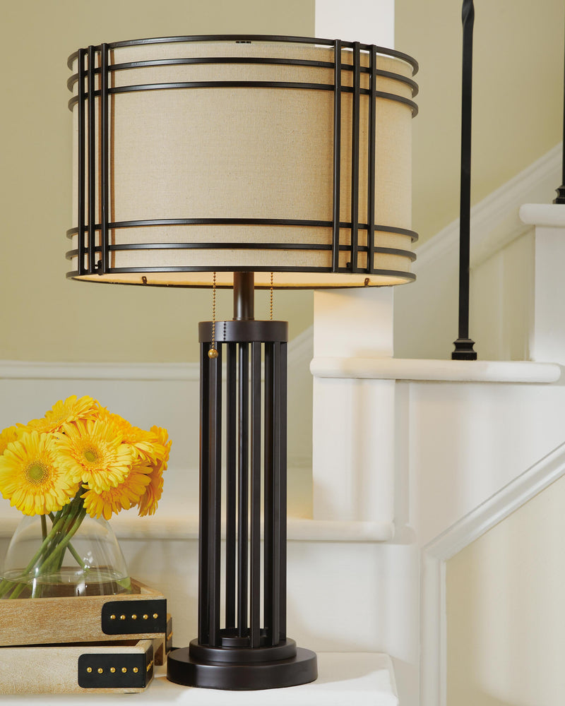 Ashley Furniture Hanswell table lamp set with two stylish lamps featuring neutral shades and contemporary bases.