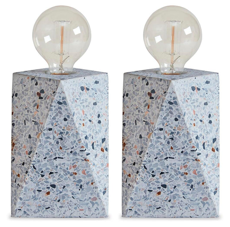 Ashley Furniture Maywick Table Lamp Set with two modern lamps featuring textured bases and fabric shades on a wooden surface.