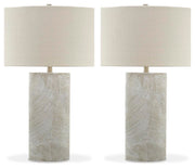 Ashley Furniture Bradard Lamp Set featuring two stylish table lamps with beige fabric shades and wooden bases on a modern side table.