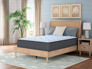Ashley Furniture Destin Cove plush hybrid mattress with a soft, quilted surface and supportive base, shown in a bedroom setting.