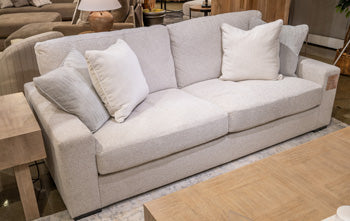 Ashley Furniture Conlee-Pike sofa with plush cushions and neutral upholstery, showcasing a modern, comfortable living room style.