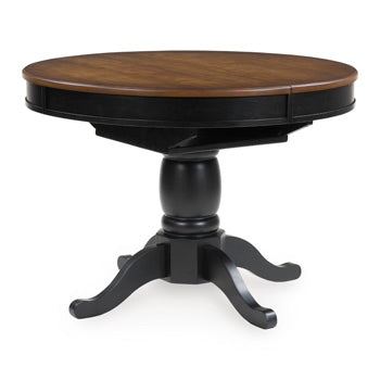 Ashley Furniture Clorazi Dining Butterfly Extension Table with wood finish and leaf extension, shown from an angled side view.