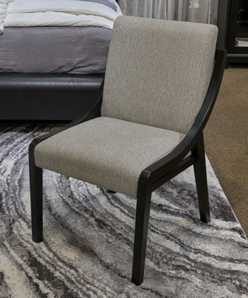 Ashley Furniture Darcyjo dining chair with upholstered seat and wooden legs, showcasing a modern, stylish design.