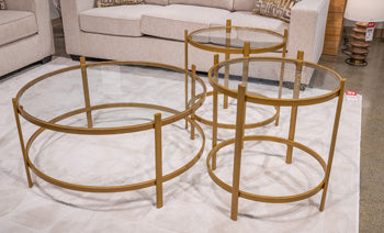 Set of three Ashley Furniture Pearlox tables with wooden tops and metal legs, arranged together in a modern living space.
