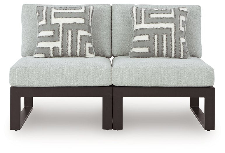 Ashley Furniture Beachloft outdoor sectional with beige cushions and woven rattan frame, ideal for patio or garden seating.