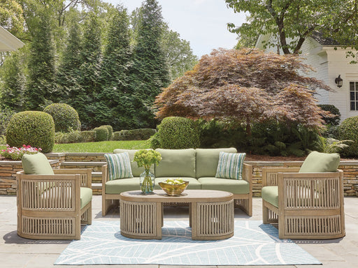 Outdoor Serena Shores outdoor seating set by Ashley Furniture with cushioned chairs and a matching table in a patio setting.