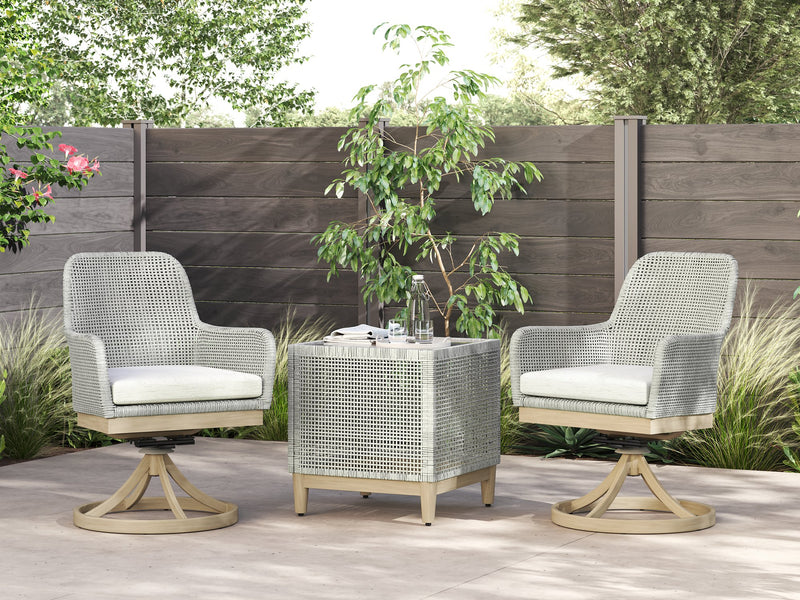 Seton Creek outdoor seating set by Ashley Furniture featuring a cushioned sofa and chairs with green cushions and a matching table.