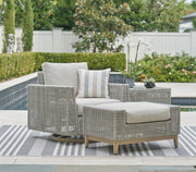 Seton Creek outdoor seating set by Ashley Furniture with cushioned chairs and a matching table, designed for patio relaxation.