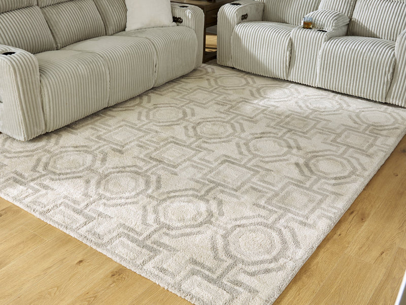 Large Maconville rug by Ashley Furniture featuring a textured, woven design in neutral tones, perfect for living room or bedroom decor.