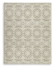 Large Maconville rug by Ashley Furniture with intricate pattern in warm tones, suitable for living room or bedroom decor.