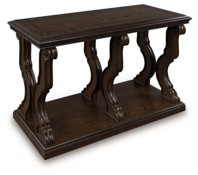 Ashley Furniture Maylee sofa table shown from an angle, featuring a sleek wooden surface and modern design for living room decor.