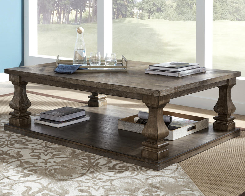 Ashley Furniture Johnelle Occasional Table Set with three matching tables featuring sleek wood finishes and modern design.