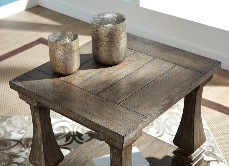 Ashley Furniture Johnelle Occasional Table Set featuring three stylish tables with wood tops and modern design.
