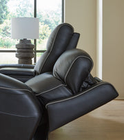 Ashley Furniture 5Z-Comfort Power Reclining Living Room Set with plush cushions and dark leather upholstery.