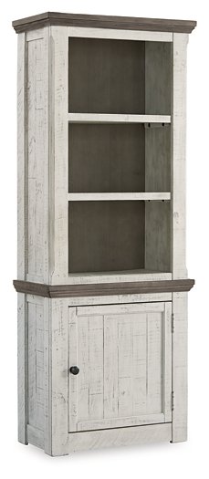 Ashley Furniture Havalance right pier cabinet with closed doors, showcasing a sleek wooden design and modern hardware.