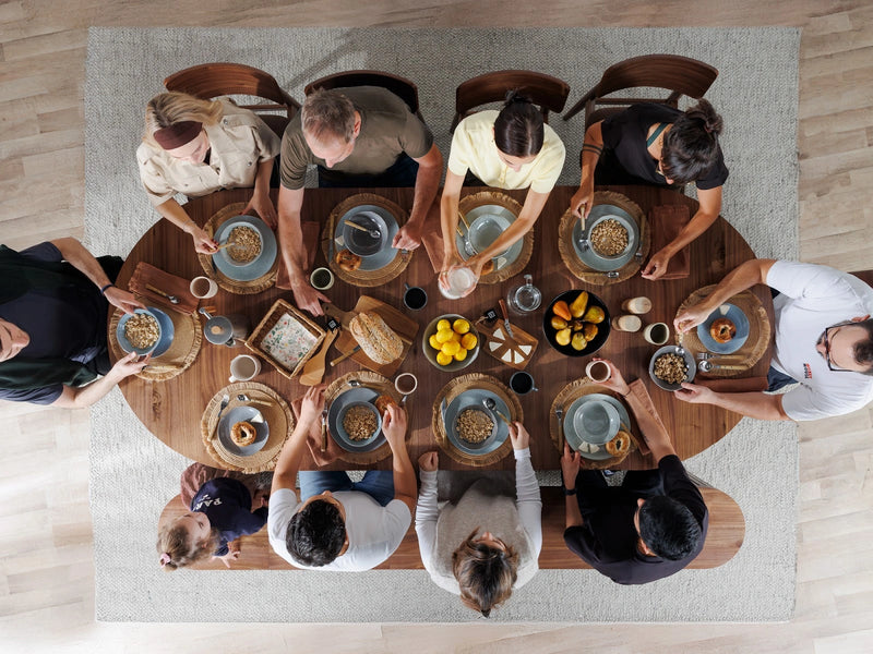 Transformer Table round dining table in wood finish, shown fully extended for dining seating