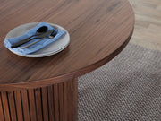 Transformer Table round dining table with a compact modern design, shown in neutral surroundings