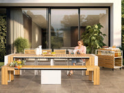Transformer Table outdoor dining set with expandable table and matching benches in a patio setting