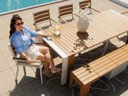Transformer Table outdoor dining set with expandable table and matching benches in a patio setting